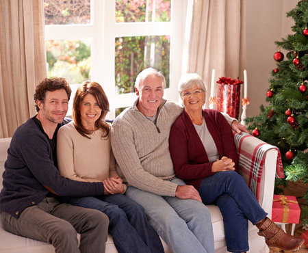 Christmas, family and together on sofa for portrait in living room to celebrate festive holiday....
