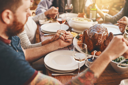 Chicken, prayer and family holding hands praying for food to God or Jesus on a Christmas holiday party at home. Trust, peace and Christian people in gratitude eating dinner at a social gatheringの写真素材