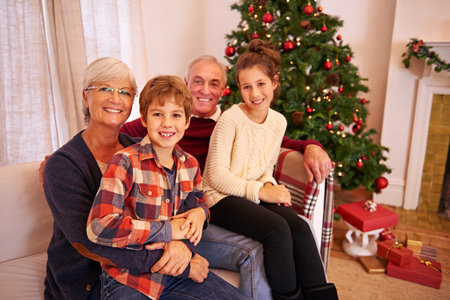 Christmas, senior couple and couch for grandchildren, happiness or relax for festive season in...