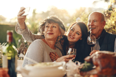 Family, phone selfie and happy thanksgiving, lunch and happy with wine, glass and social media photo...