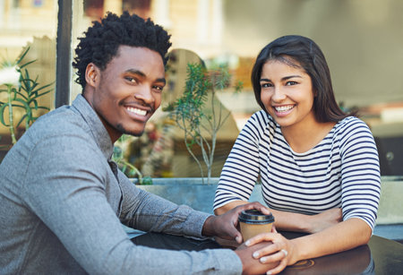 Happy couple, coffee and portrait smile at cafe for relationship bonding or date together at a coffee shop. Man and woman smiling in happiness for quality time or dating on table at a restaurantの写真素材