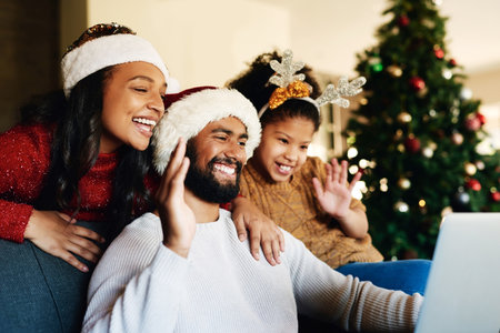 Christmas, family and video call, wave and communication for holiday celebration with laptop and happy family from Mexico. Technology, virtual and celebrate, Christmas tree decoration and talk onlineの写真素材