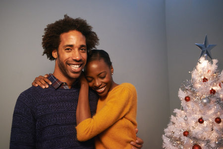 Feeling the love on Christmas. Portrait of a loving young couple on Christmas.の写真素材
