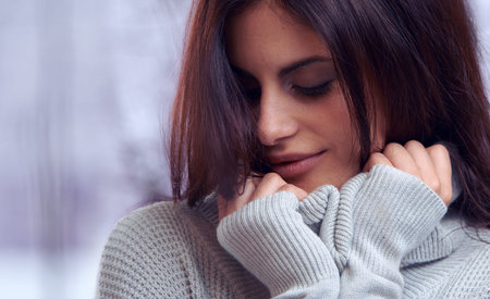 Stunning snuggles. an attractive brunette outdoors in winter.