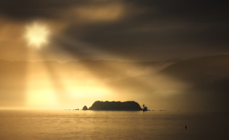 A photo of sunset - ocean and mountainsの写真素材