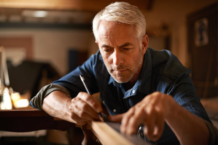 He had an eye for detail. a senior builder working on a project in his workshop.