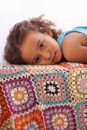 Getting sleepy...Portrait of an adorable little girl lying down.