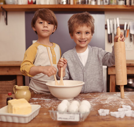 Were gonna be the best bakers ever. two young brothers baking in the kitchen.の写真素材