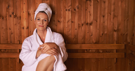 Enjoying the simple things in life. a mature woman in a sauna.の写真素材