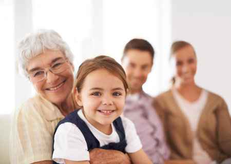 They have a special bond. Portrait of a grandmother hugging her granddaughter with her parents in...