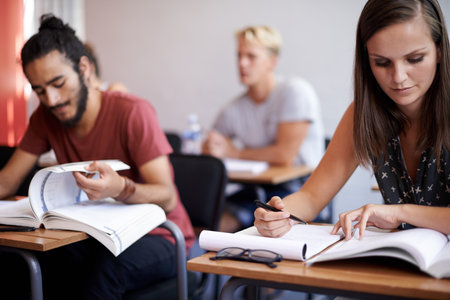 Theyve got great study habits. a group of university students studying together.の写真素材