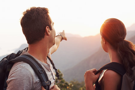 Were headed to that point there...A young man pointing towards the horizon while his girlfriend...