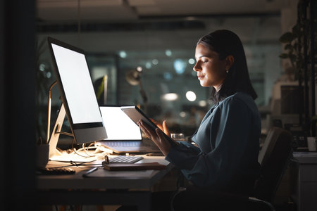 Business woman, computer or tablet in night office for digital marketing planning, seo advertising strategy or brand web design. Creative worker, employee or technology working late on startup growthの写真素材
