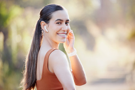 Fitness, music and park with woman in portrait for outdoor streaming with 5g network wellness,...
