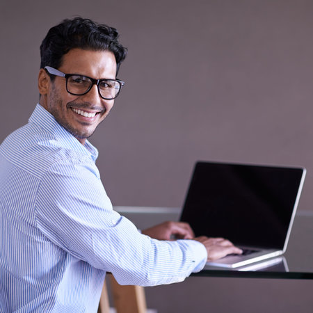 Hes working hard to complete his tasks. a handsome young businessman working at his desk.