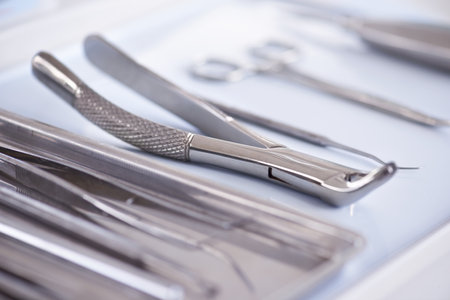 The tools of the trade. Closeup view of dental surgical instruments lying in a row.の写真素材