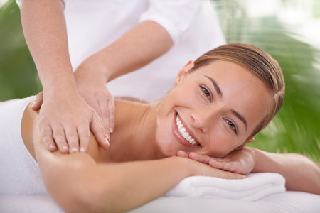 This is perfect relaxation. A young woman on a massage table in a spa.の写真素材