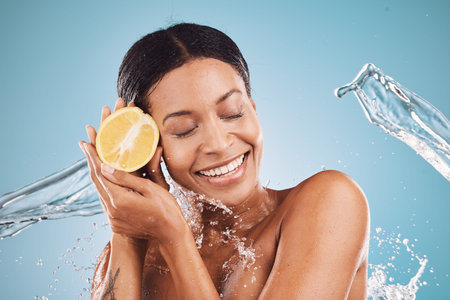 Lemon, skincare and black woman with a beauty water splash, product marketing and nutrition against...