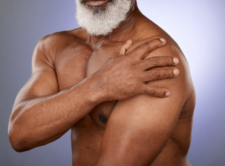 Hand, arm pain and senior man in studio for injury, arthritis and joint ache on blue gradient background. Chest, elderly man and shoulder pain with mockup for heart attack, distress and cardiac signの写真素材