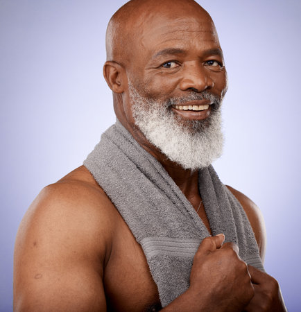 Portrait, black man and shower with towel for healthy skincare, hygiene and wellness on studio background. Male beauty, clean body care and mature guy happy after spa sauna, bathroom and cosmeticsの写真素材