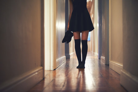 On her way out. Cropped image of a young woman walking down the hallway in her house.の写真素材