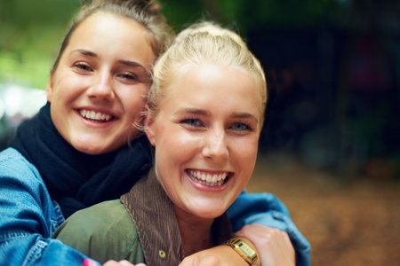 This year were hitting the festival together. Portrait of two young women having a good time at an outdoor festival.の写真素材