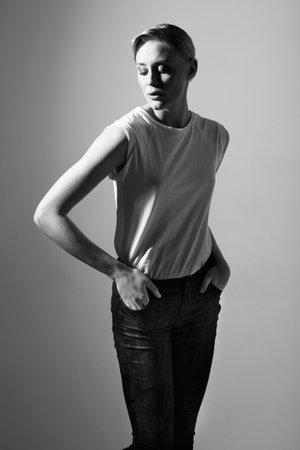 Striking a classic pose. Black and white image of a beautiful woman posing in casual wear.の写真素材