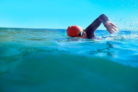 Enjoying the cold fresh water. a swimmer in the open ocean.の写真素材