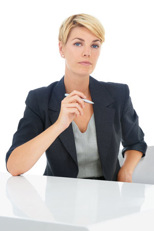 Lets get to business. Portrait of a young businesswoman sitting at her desk.の写真素材