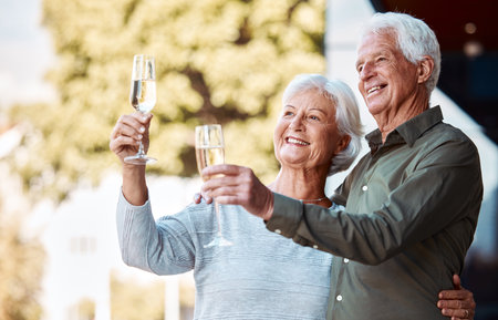 Senior couple, champagne toast and hug with love, relationship happiness and care in home backyard. Elderly man, woman and glass for celebration, romance or marriage anniversary with smile in summerの写真素材