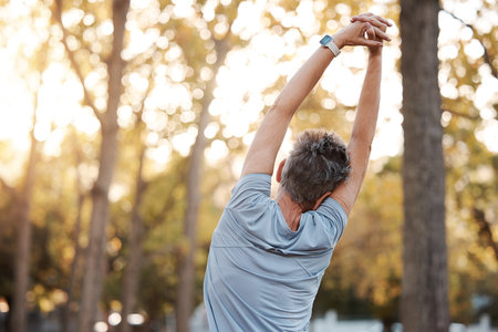 Stretching, fitness and man in park for muscle and body workout, wellness and health in nature with...