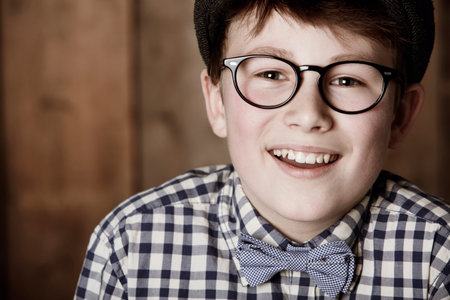 Positive and smart. Cropped portrait of a young boy in retro clothing wearing spectacles while...