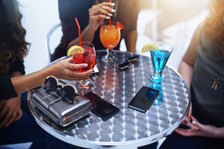 Hands of women, drinks and friends at club table, having fun and bonding. Party, celebration and...