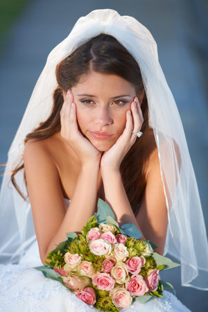 Wedding jitters. a sad-looking young bride on her wedding day.の写真素材