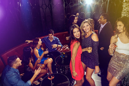 Friends, group and party in disco, club or happy for celebration for new year in night for dancing....