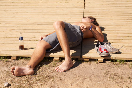 Party pass out. A shirtless young man passed out at a music festival.の写真素材