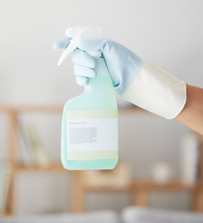 Cleaning, spray bottle and hands of woman in home for bacteria, safety and sanitary. Hygiene, chemicals and housekeeping service with cleaner and disinfection product for germs, dirt and domesticの写真素材