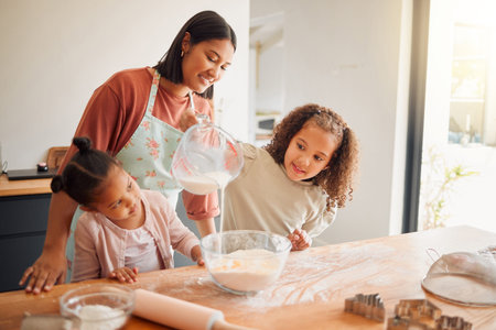 Females only, happy mixed race family of three cooking in a messy kitchen together. Loving black...
