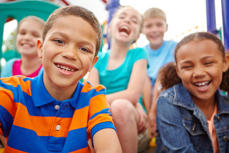 Theyre the faces of our future. A multi-ethnic group of happy children playing on a jungle gym in a...