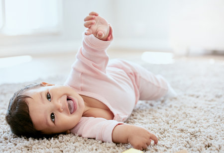 Can I have your attention please. an adorable baby girl lying on the floor at home.