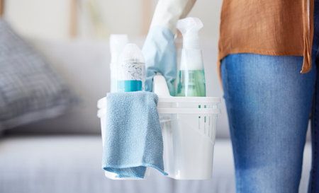 Woman, hand or cleaning container in house, home or hotel living room in hygiene maintenance, housekeeping or bacteria control. Zoom, fabric or spray bottle for maid, cleaner or spring cleaning workの写真素材