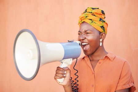 Megaphone, black woman or african protest, justice and freedom of speech for gender equality on orange mockup. Vote, human rights and race of woman with voice for politics, angry broadcast or newsの写真素材