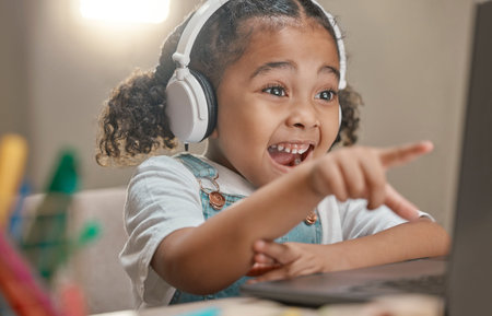 Student, education and remote learning with an excited black girl in her home using a laptop and...