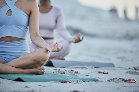 Hands, yoga and friends on the beach for spiritual health and wellness workout or exercise. Training, friendship and yogi women meditating on yoga mats on the seaside sand for grattitude and mindsetの写真素材