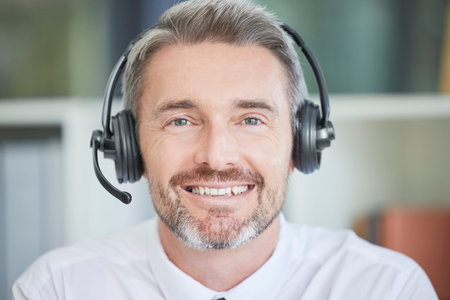 Call center, customer service and sales with a man consulting using a headset in his sales office....
