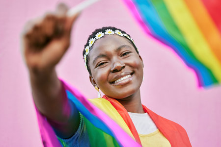 LGBT, pride and portrait of black woman with rainbow flag for self love, individuality and support for the LGBTQ community. Equality, human rights and face of bisexual, gay or lesbian African girlの写真素材