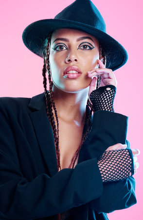 Portrait, fashion and beauty with a model black woman in studio on a pink background for...
