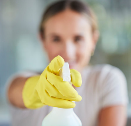 Hand, spray bottle and cleaning with a woman in gloves for housework or sanitization for hygiene. Hands, latex and disinfectant with a female cleaner spraying product to clean for a fresh washの写真素材