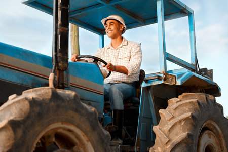 What would be the best crops to plant next season. a young farmer driving a tractor on a farm.