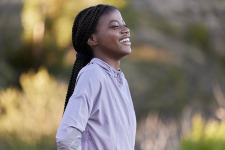 Black woman, fitness and happy thinking in nature on running break with cheerful smile. Happiness,...